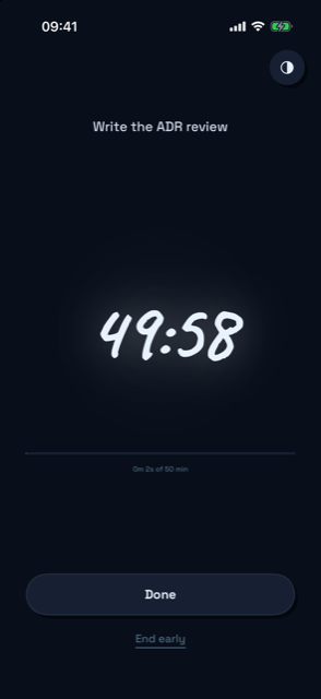 Through's Running screen — the timer steps back and the intent sentence stays in front